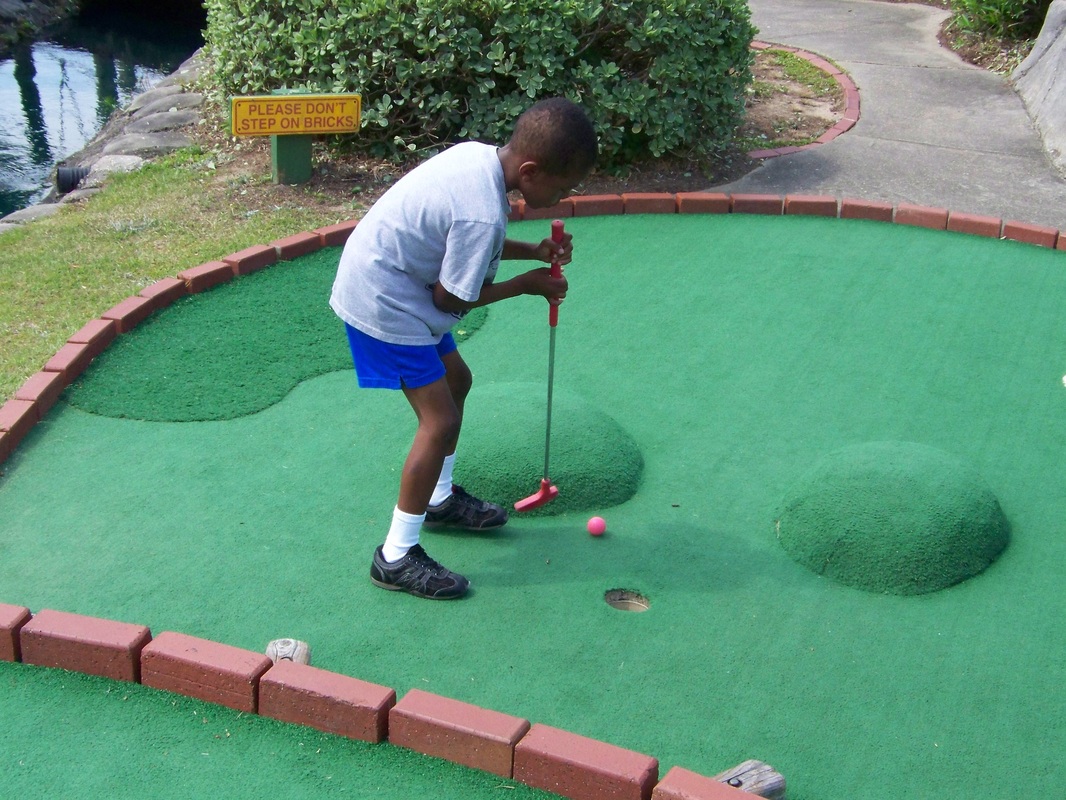 Child playing put put golf