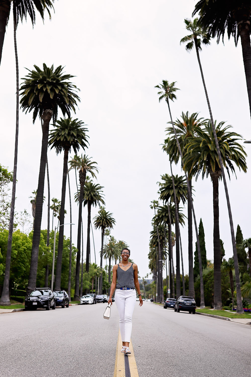 Tamieka Smith surrounded by the palm trees in Beverly Hills, a family photographer in Beverly Hills