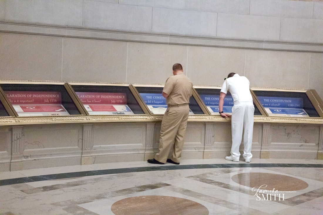 Looking at documents inside the National Archives Museum before a Navy Promotion Ceremony