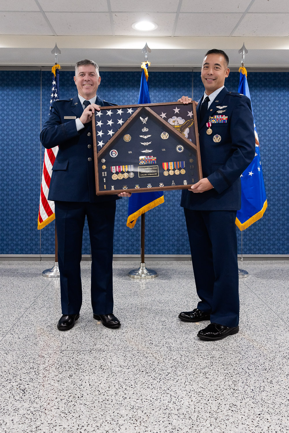 Lt Col Atienza receives his shadow box at his retirement ceremony inside the Pentagon