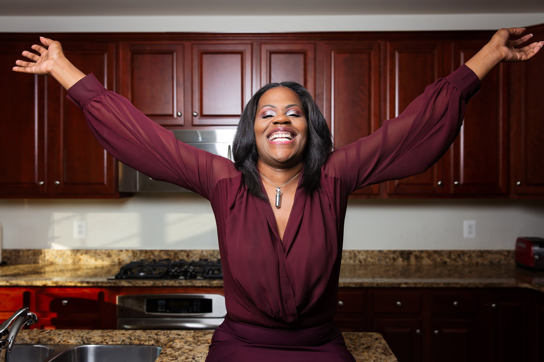 Lady celebrating the purchase of your home in Woodbridge by Woodbridge Family Photographer Tamieka Smith