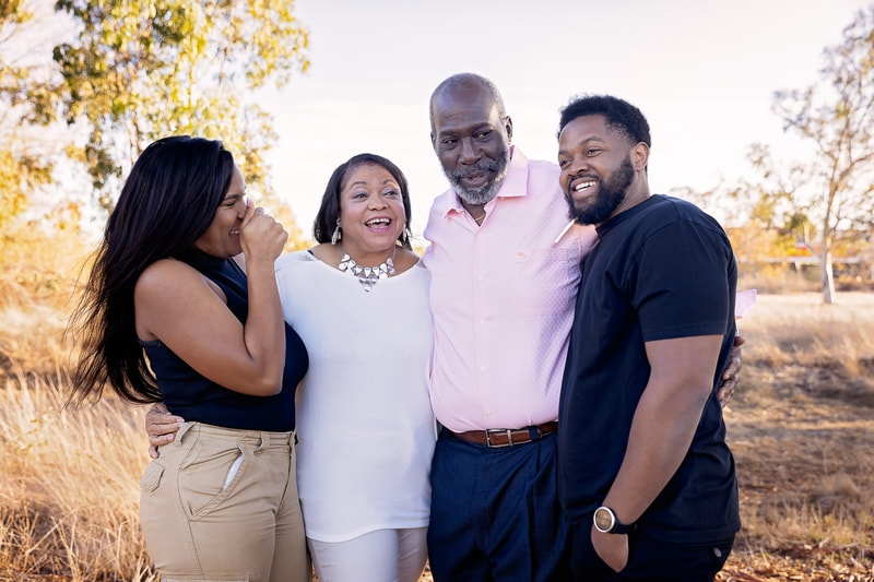Del Aire Baptist Church Pastor Jefferson and his family of four smiling at Torrance Del Amo Marsh for family pictures with South Bay Photographer Tamieka Smith.  