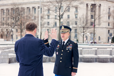 Tamieka Smith Photography, a National Archives Photographer, captures a stunning image of an Army officer's promotion ceremony in front of the National Archives Museum in Washington D.C., surrounded by snow. Tamieka's skillful use of lighting, composition, and creativity transforms this special moment into a breathtaking work of art. Hire Tamieka to document your Army promotion ceremony, and you'll receive exceptional, high-quality images that capture the pride, honor, and achievement of the Army community. Trust Tamieka to skillfully document every aspect of the ceremony, from the official proceedings to the unique elements of the surrounding environment. Tamieka Smith Photography is the perfect choice to make your Army promotion ceremony an unforgettable experience.