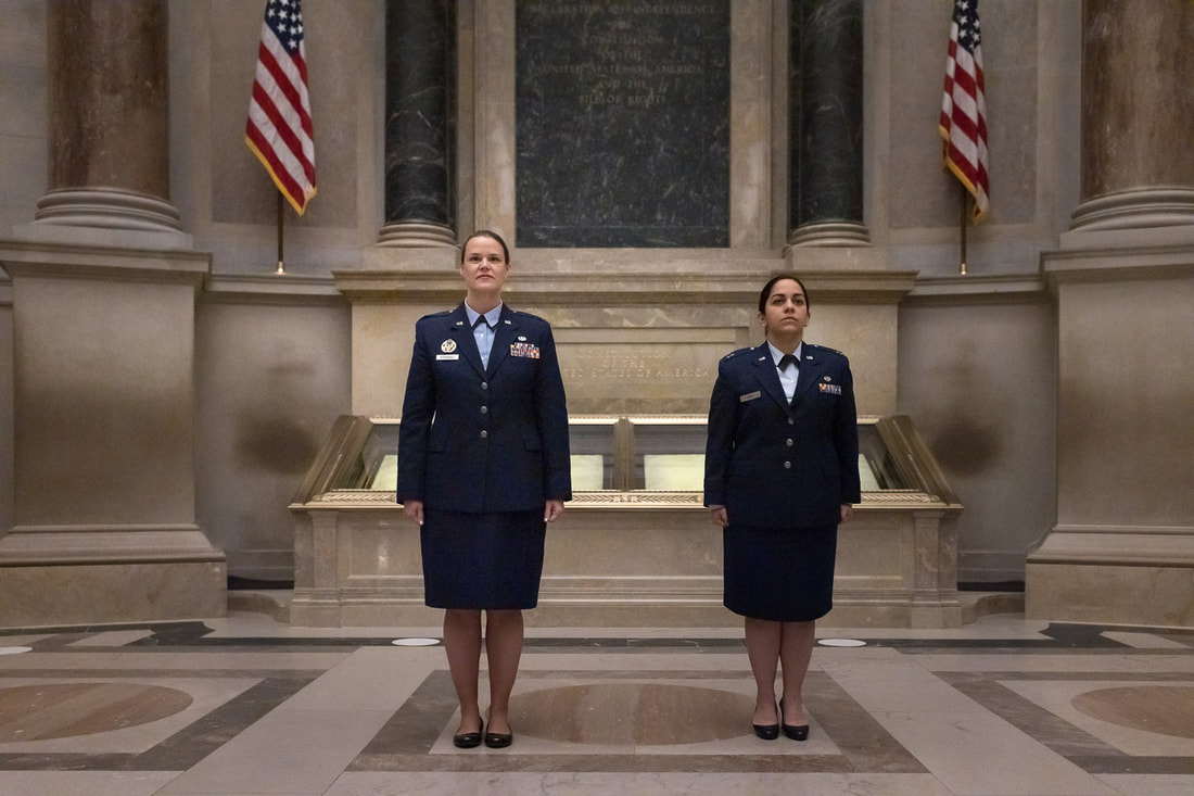 Air Force members standing at attention inside the Archives Rotunda for a military promotion ceremony