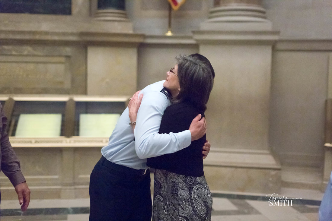 Air Force Officer hugs his Mom in the National Archives Museum in Washington D.C.
