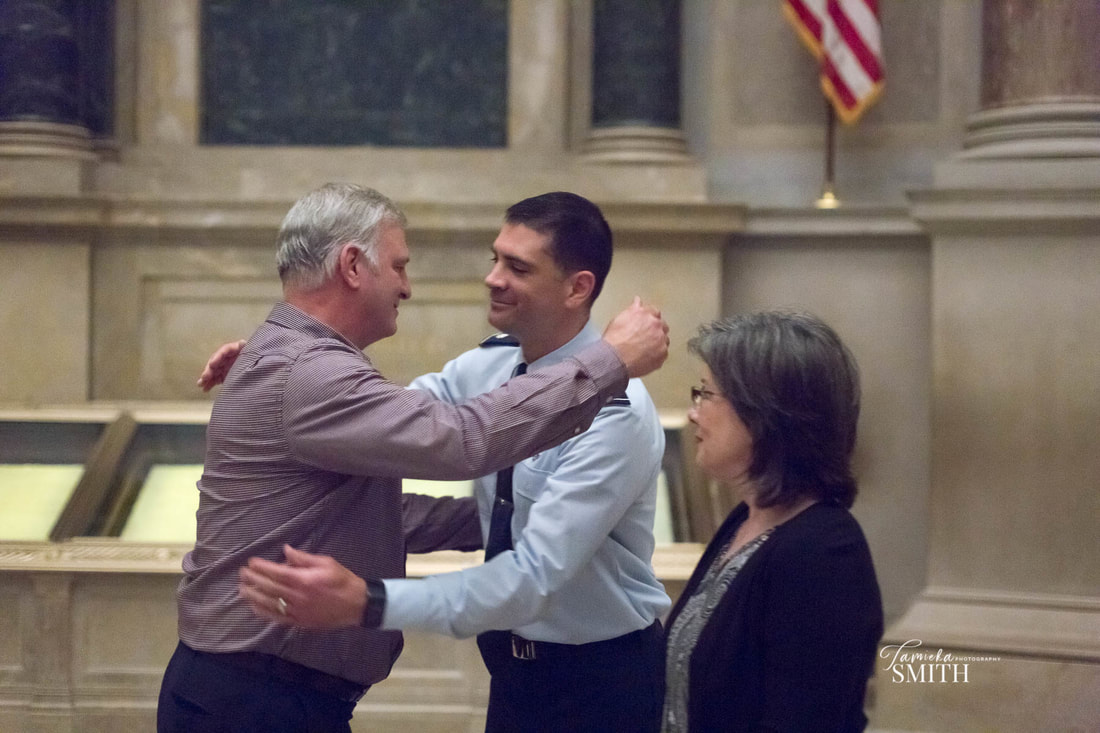 Air Force LtCol Officer hugs his Dad in the National Archives Museum in Washington D.C.